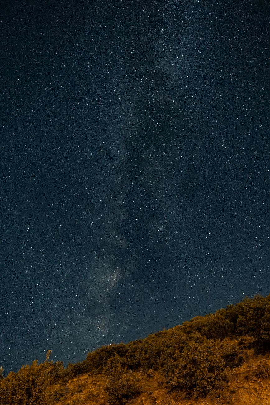 Captivating view of a starry night sky with the Milky Way above a hill.